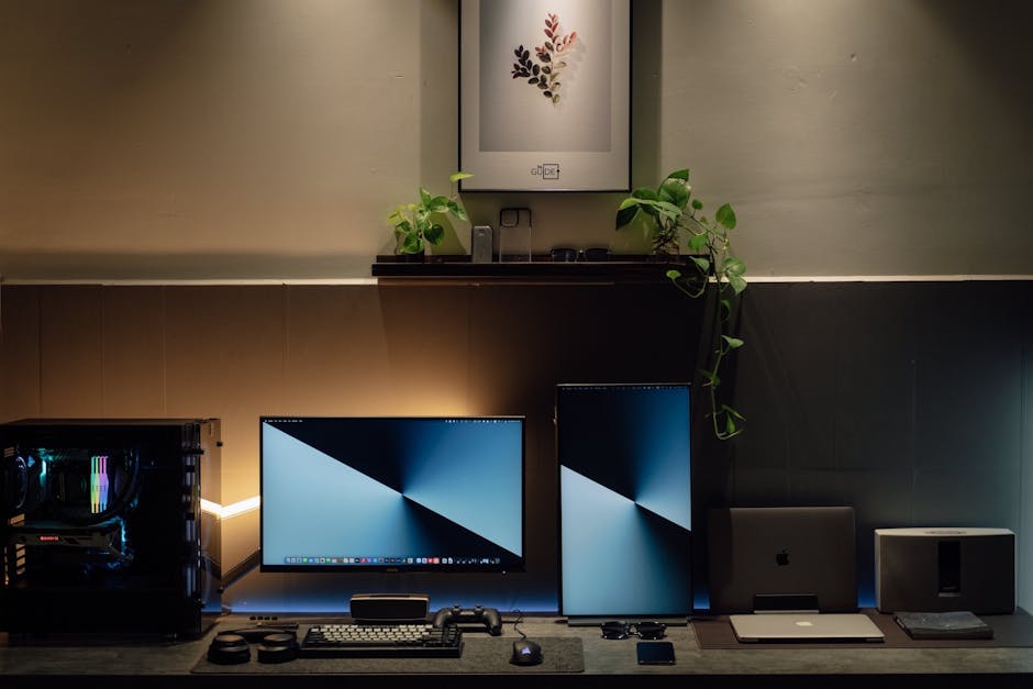 A sleek home office setup with dual monitors, potted plants, and tech gadgets